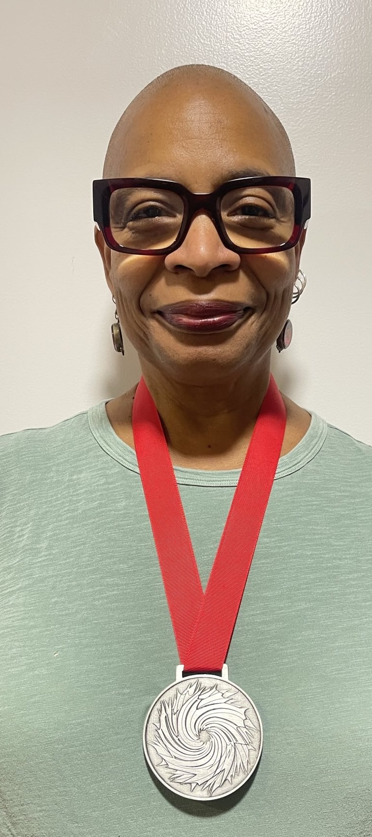 Nalo Hopkinson wearing the Sunburst Award medallion